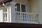 Open white concrete balcony on the wall of the house