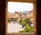 Open window of the Amber Fort and people walking around the historical stone palaces