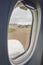 Open window with raindrops. Comercial aeroplane. Cabin interior