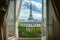 An open window reveals a clear view of the iconic Eiffel Tower in Paris, An Eiffel Tower view from a Parisian apartment, AI