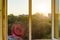 Open windows in the apartment. Background evening sunset, city silhouette