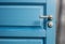 Open wooden door painted in blue color