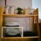 Open wooden shelves in the kitchen, pantry. View of the organized kitchen