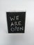 We are open written on a chalkboard on a white background