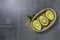 Opened avocado showing seed on textured stone background