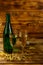 Opened champagne bottle and two glasses of champagne on wooden table