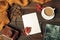 Opened craft paper envelope , autumn leaves and coffee on wooden table