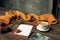 Opened craft paper envelope , autumn leaves and coffee on wooden table