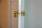 Opened Cream white door and gold knob lock