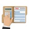 Opened folder with tax form, and the man`s hand, count taxes on the calculator. Tax calculation, payment or return concept