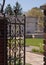 An opened gate leading into a garden