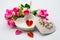 Opened heart box with mini handcraft inside with decoration bouquet of roses on white background