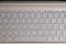 Opened modern laptop keyboard with USA alphabet on keys front top view closeup