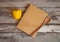 Opened notebook for notes and yellow sweet pepper on aged wooden background