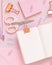 Opened notebook and Pink school girly accessories on pastel pink Top view, mockup
