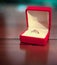 Opened red jewelry case with engagement ring. Close-up.