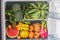 Opened refrigerator full of vegetarian healthy food, vibrant colour vegetables and fruits inside on fridge. Vegan Fridge