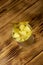 Opened tin can of pineapple pieces on wooden table