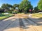 Opened yellow fire hydrant gushing water across a residential street near Dallas, Texas, USA