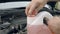 Opening bottle with pink windshield washer fluid