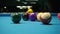 Opening Break Shot of Eight Ball Pool Game Spreading Balls Around Blue Fabric Table Surface