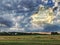 Opening cloudy skies over summer farmland