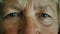 Opening eyes, The face and eyes of an old woman. close-up face. portrait of an elderly woman.