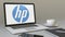 Opening laptop with HP Inc. logo on the screen. Modern workplace conceptual editorial 4K clip