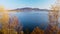 Opening scene. View on lake with hills on horizon, moving trees underneath