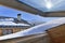 Opening window on a roof covering with snow in an alpine cottage