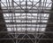 Openwork metal trusses of a huge roof in a hypermarket