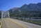 Openwork web of transport metal bridge over the Columbia River amid majestic forested mountains