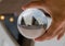 Opera house with cloudy sky photography in clear crystal glass ball.