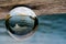 Opera house photography in clear crystal ball at sunset time.