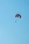 The operated parachute flies in high in the blue sky