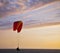 The operated parachute flies low above the sea