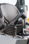 Operating control panel and black vehicle seat in background, detail of industrial agricultural machine