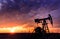 Operating oil and gas well and sunset sky