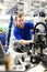 operator assembles machine in a factory - production of switch cabinets for industrial plant - portrait worker