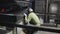 The operator of the furnace watching the process of bending glass.