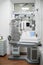 Ophthalmological cabinet with modern equipment in a medical clinic featuring an examination chair and phoropter, ready