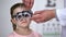 Ophthalmologist changing lens in eye testing glasses to diagnose child vision