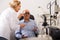Ophthalmologist female and male pensioner check eyesight in clinic