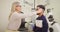 Ophthalmologist giving male patient an eye test in an exam room. Female optician or optometrist specialist checking