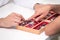 Ophthalmologist hands close up, showing a tray with different glasses to a customer.