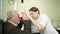 ophthalmologist measures interpupillary distance of elderly man. pupillometer