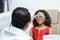 Ophthalmologist or optometrist examining eyesight of Indian child girl with trial frame and lens for eyes test at hospital