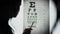 Ophthalmologist performing eye examination, taking vision test