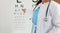 Ophthalmologist standing on background of table measuring vision closeup