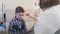 Ophthalmologist treatment - woman doctor about to check the eyes of a little boy